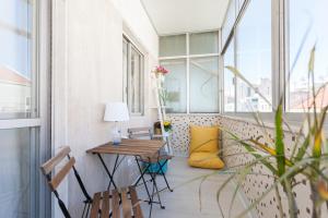 リスボンにあるFLH Marques Modern Flatのバルコニー(テーブル、椅子付)、窓