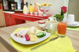 a plate of food on a table with a drink at Le Grand H&ocirc;tel de Normandie in Paris