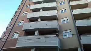 a tall building with balconies on the side of it at Lux Life Apartment in Belgrade