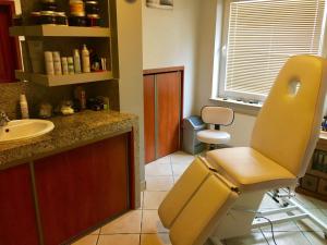 a bathroom with a sink and a chair in it at Ski&Spa Zieleniec in Zieleniec