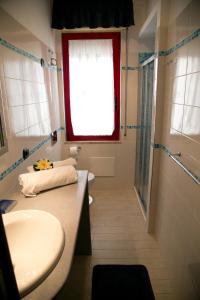 a bathroom with two sinks and a shower and a window at Casa Putti in Letojanni