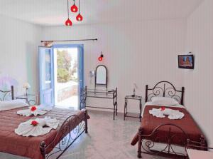 a bedroom with two beds with towels on them at Ios Memories in Mylopotas