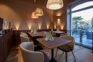 a dining room with a table and chairs at Ebner - Boutique-Hotel & Konditorei in Lindau