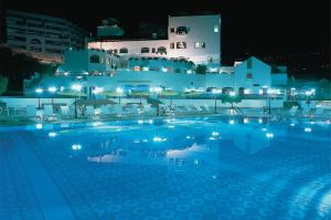 a swimming pool at night with a building in the background at Regency Palace Hotel in Jounieh