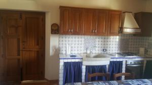 a kitchen with a sink and a counter top at Vecchio Baglio Cofano in Custonaci