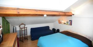 a bedroom with a blue bed and a ladder at Appart' Charmettes in Lyon