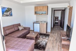 a living room with a couch and a kitchen at Apartments Timoni in Ulcinj