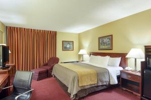 A bed or beds in a room at Quality Inn