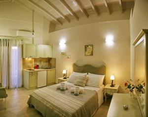 a bedroom with a bed with two towels on it at Victoria Studios in Panagioúda +54 photos