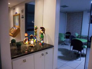 a group of figurines on top of a kitchen counter at Pousada Pérola Dourada Maceio in Maceió