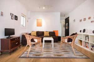 a living room with a couch and a table and chairs at Apartment Vallhonrat in Barcelona