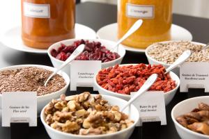 a table with bowls of different types of food at La Villa Haussmann in Paris