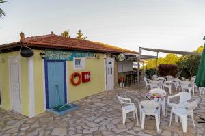 a building with tables and chairs in a patio at SeaView Apartments in Tsilivi