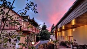 a building with a sunset in the background at The Originals Boutique, Hôtel Clos Sainte Marie, Nevers in Nevers