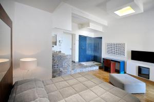 a bedroom with a large bed and a fireplace at Villa Battista in Ercolano