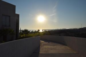 a view of the sun setting over the ocean at Amphora Hotel & Suites in Paphos