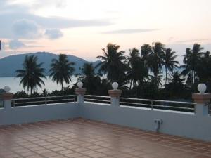 balcón con vistas al océano y a las palmeras en Raya Rawai Place, en Rawai Beach