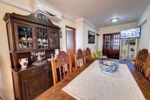 a dining room with a table and a china cabinet at Bragança Apartments in Bragança