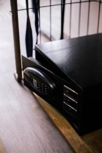 a black microwave sitting on top of a wooden floor at M Boutique Kampar in Kampar