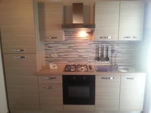 a kitchen with a stove and a sink at Appartamento Vincenzina in Lampedusa