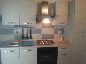a kitchen with a stove and a sink at Appartamento Vincenzina in Lampedusa
