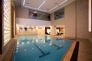 a large swimming pool in a building with a hotel at Radisson Blu Hotel, Diyarbakir in Diyarbakır