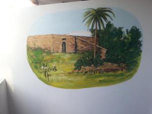 a painting of a building on a wall at Appartamento Vincenzina in Lampedusa