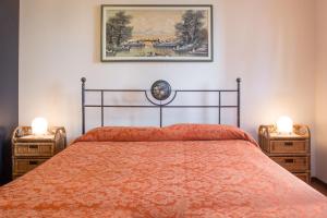 a bedroom with a bed and two night stands at B&B La Gatta Blu in Cattolica