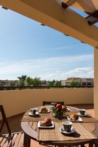 a table with plates of food on a balcony at Casedamare in Polignano a Mare