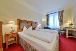 Postel nebo postele na pokoji v ubytování Hotel Post Murnau