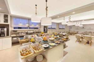 a large kitchen with a long buffet of food at Hotel Rivage in Sorrento