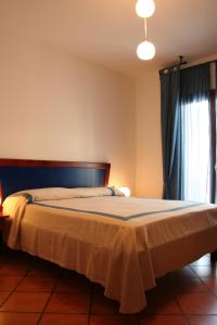 a bedroom with a bed and a window at Hotel Locanda dei Trecento in Sapri