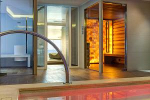 a bathroom with a tub and a fireplace in a house at Almar Jesolo Resort & Spa in Lido di Jesolo