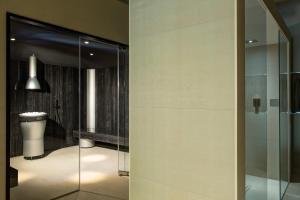 a bathroom with a glass shower and a toilet at Almar Jesolo Resort & Spa in Lido di Jesolo
