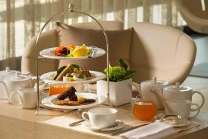 a table with three plates of food on a table at Almar Jesolo Resort & Spa in Lido di Jesolo