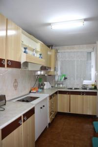 a kitchen with wooden cabinets and white counters at Casas los Rosales in Guadix