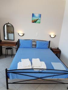 A bed or beds in a room at Iliovasilema VILLAGE