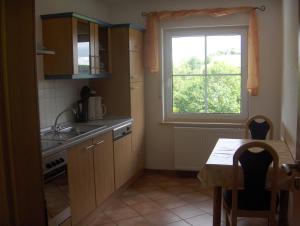 a small kitchen with a table and a window at Schweizes Ferienhof in Medebach