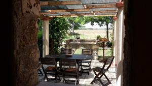 a patio with a table and chairs on a patio at Agriturismo Casal Taccone in Tarquinia +37 photos