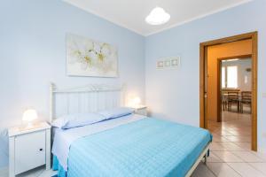 A bed or beds in a room at Residence Kimba