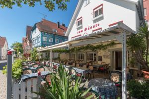 a row of tables and chairs in front of a building at Zum Fässle in Hagnau