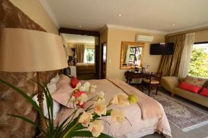 a bedroom with a bed with flowers on it at Summerview Boutique Hotel & Conference in Johannesburg