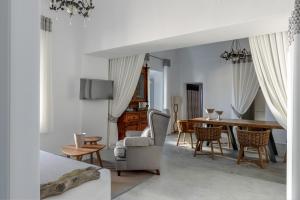 a bedroom with a table and chairs and a dining room at Andromaches - by Senses Collection in Pyrgos