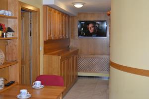 a room with a tv on the wall and a table at Privat Pod Skalkou in Velké Losiny
