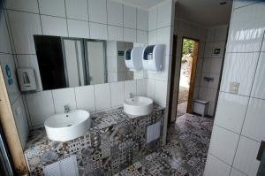 a bathroom with two sinks and a mirror at Camping Yellow Plum in Puerto Natales +24 photos