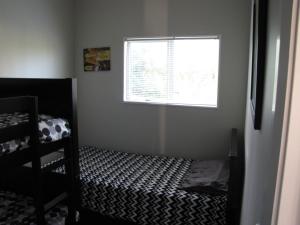 a small bedroom with a bed and a window at Cruz Inn in Featherston