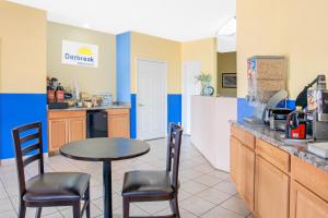 a kitchen with a table and chairs and a counter at Days Inn by Wyndham Moulton in Moulton