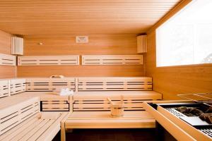 a sauna with a bench and a table in it at Südkap F-03 in Pelzerhaken
