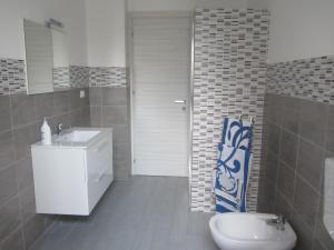 a bathroom with a white sink and a toilet at Casa Normanna in Monreale +27 photos