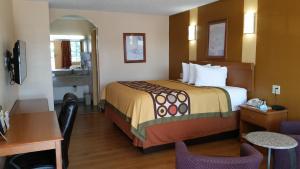 A bed or beds in a room at Super 8 by Wyndham Waco/Mall area TX